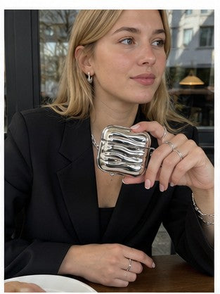 chrome wave sculpted airpods case lifestyle image